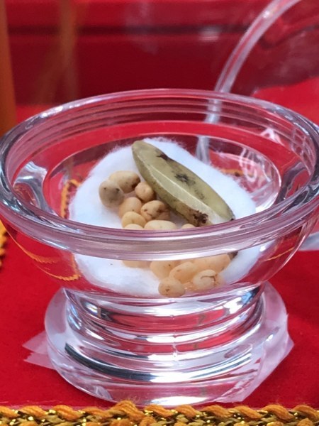 พระทันตธาตุหลวงปู่ครูบาชัยยะวงศา แกะเป็นรูปพระพุทธรูป พร้อมกับพระธาตุข้าวบิณฑ์