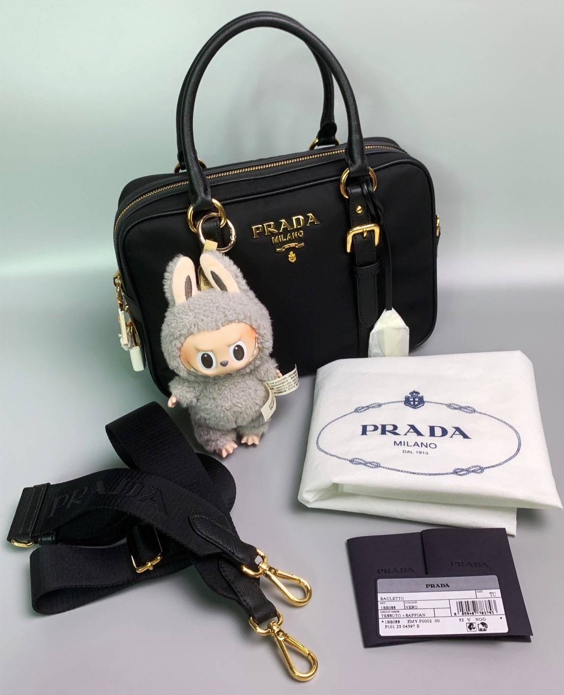 New Prada Tessuto + Saffiano Bauletto Bag • Size : 10” (L) x 7.5” (H) x 3.5” (D)
