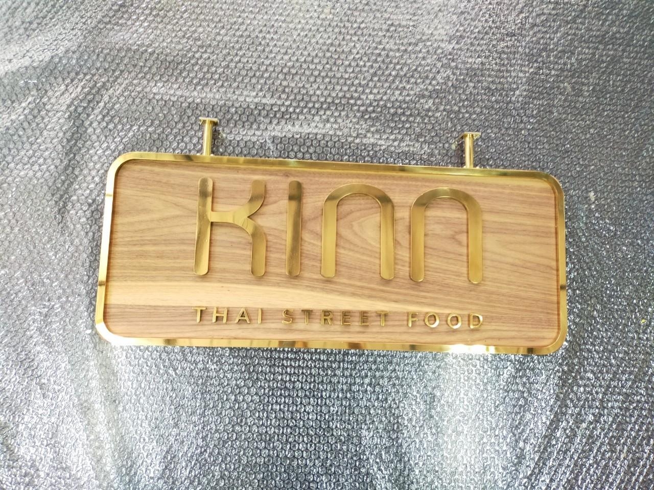 ป้ายอักษรทองเหลืองขัดเงา ยกขอบ รองพื้นไม้