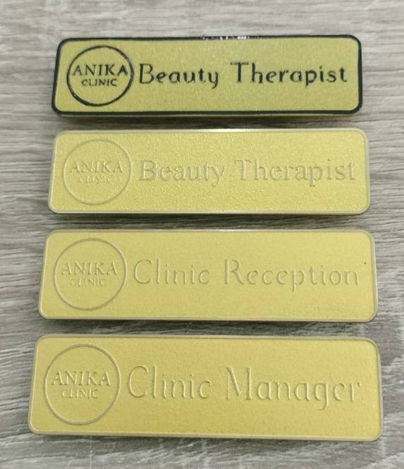 #ป้ายไทเทเนียมกัดกรดทองติดเข็มกัด